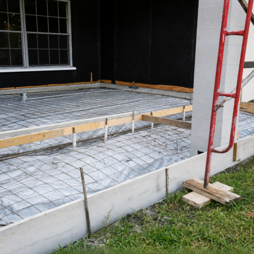 Project Archive addition construction site preparation on grassy edge.webp