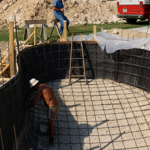 Project Archive outdoor construction site in progress with pool excavation